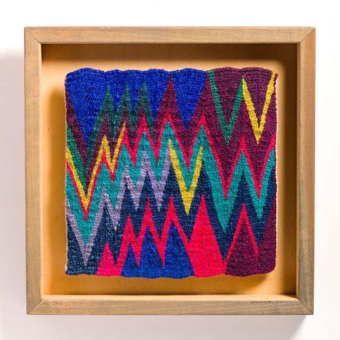 A picture of a colorful chevron pattern in a wooden frame