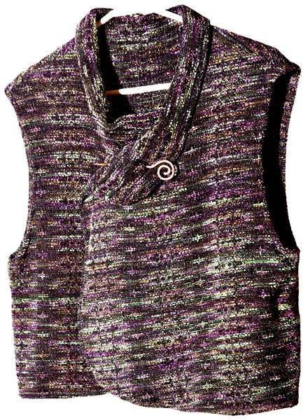 A purple vest is hanging on a hanger on a white background.