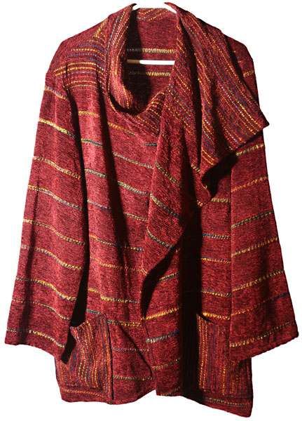 A red sweater is hanging on a hanger