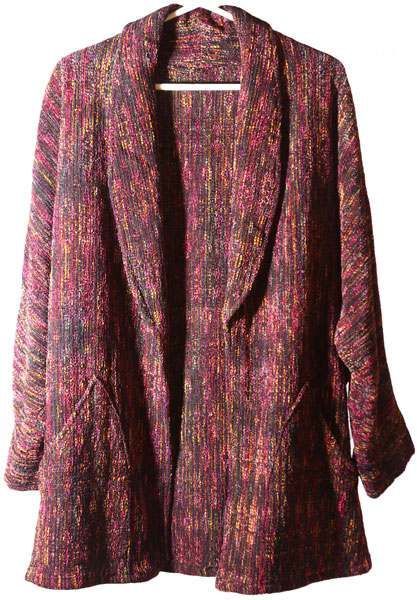 A colorful jacket is hanging on a white hanger