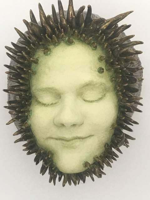 A close up of a face with spikes around it