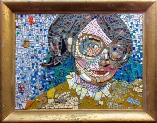 A mosaic portrait of a woman wearing glasses