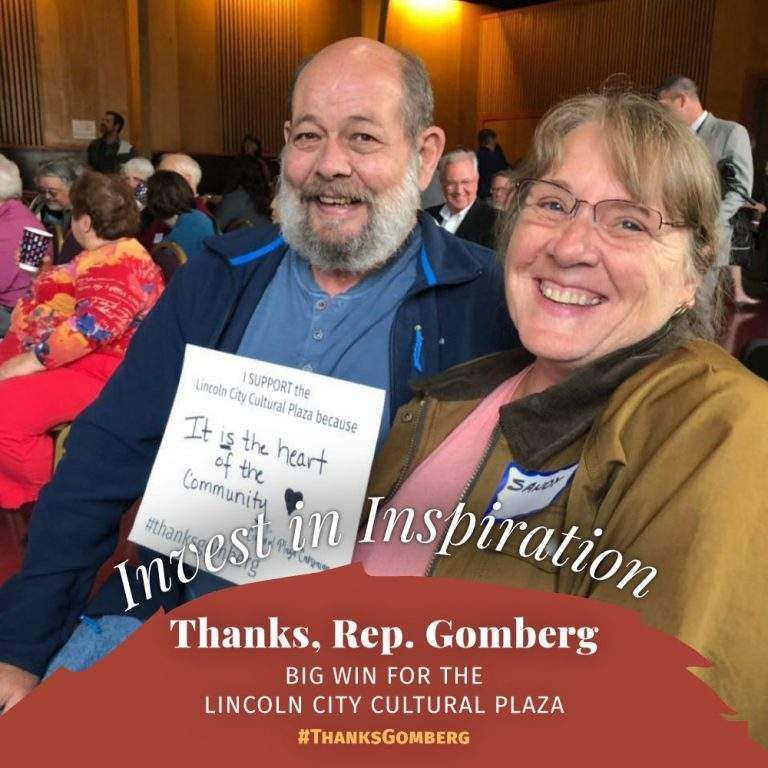 A man and woman holding a sign that says