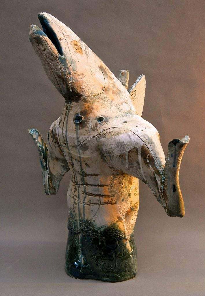 A statue of a whale with its mouth open