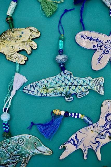A bunch of fish shaped ornaments on a blue background