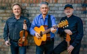 Three men are standing next to each other holding guitars and violins.