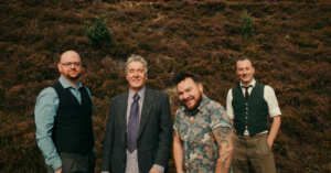 A group of men are standing next to each other in a field.