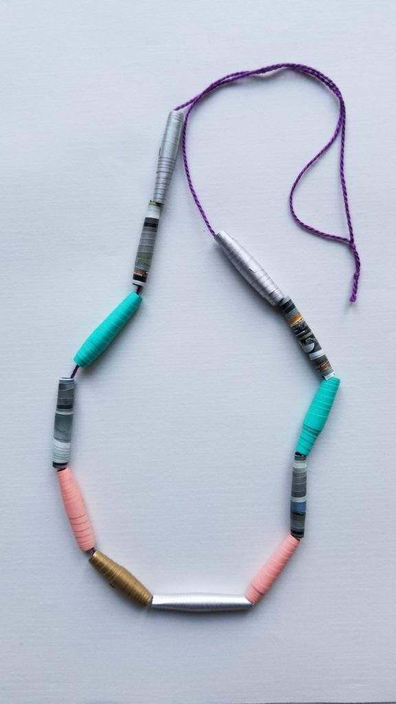 A necklace with colorful beads and a purple string