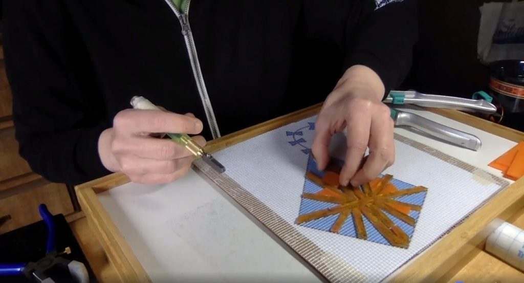 A person is painting a picture on a piece of paper with a brush.