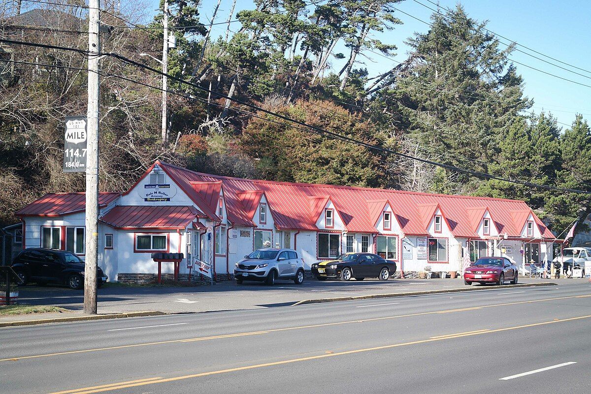 7 Gables shops (across the street from LCCC) A row of motels with red roofs are lined up on the side of the road.