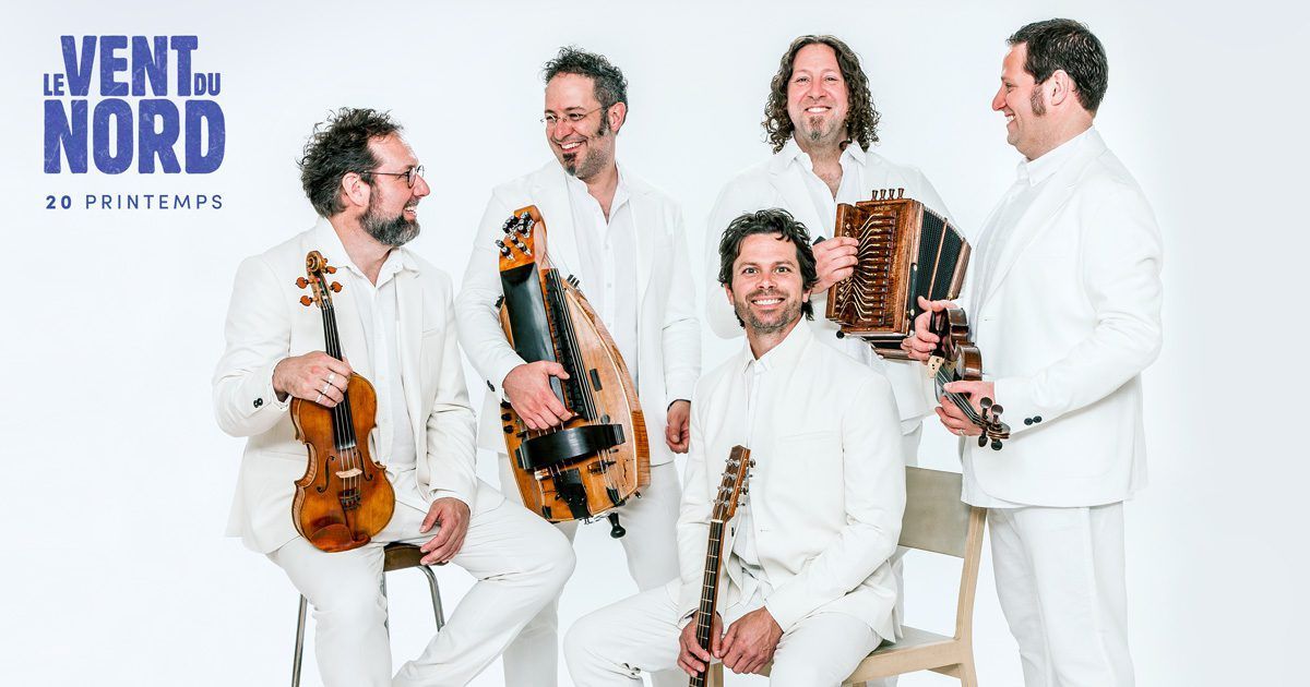 A group of men standing next to each other holding musical instruments.