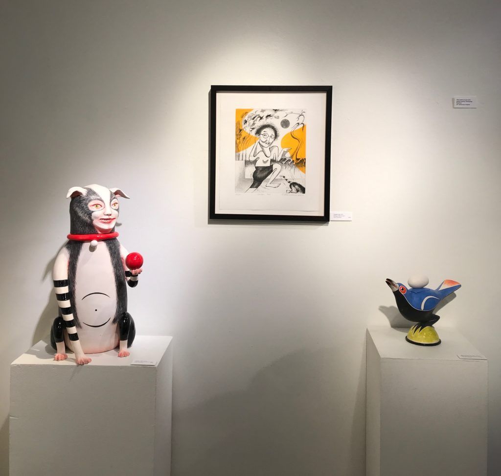 A cat in the hat statue is on display in a museum