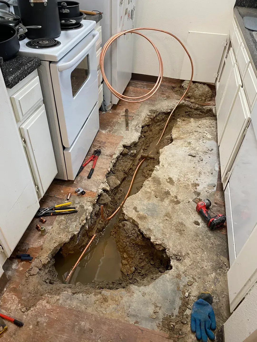 A pipe is leaking water into a basement.