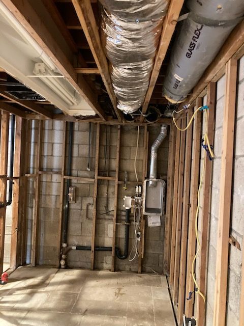 A room with a lot of pipes hanging from the ceiling in Huntington Beach.