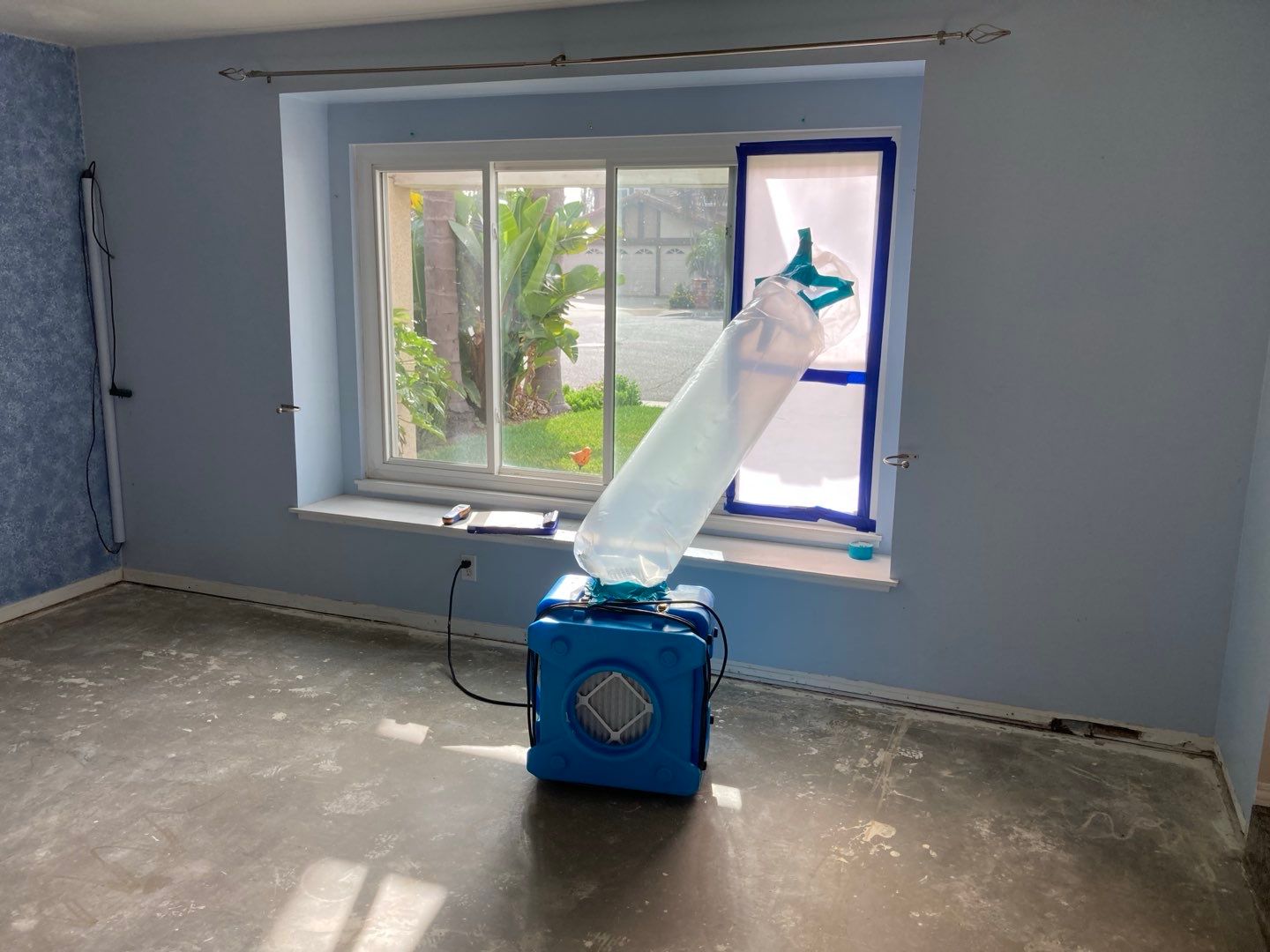 A room with a window and a machine in front of it in Huntington Beach.