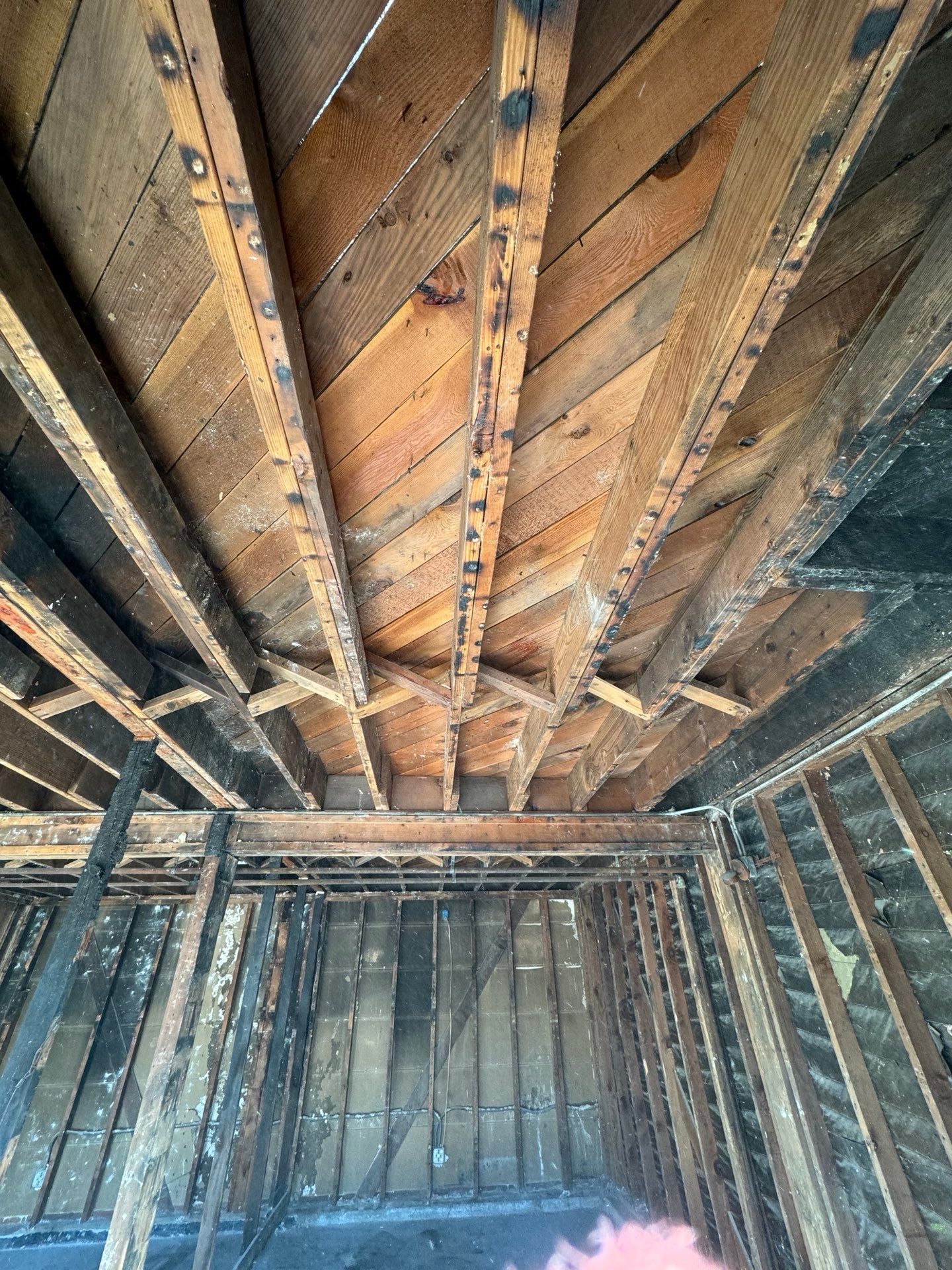 Looking up at the ceiling of a building with wooden beams in Huntington Beach.