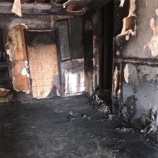 A room in a house that has been damaged by a fire in Huntington Beach.