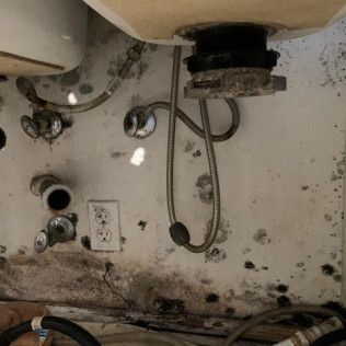 A bathroom sink with a lot of wires coming out of it in Huntington Beach.