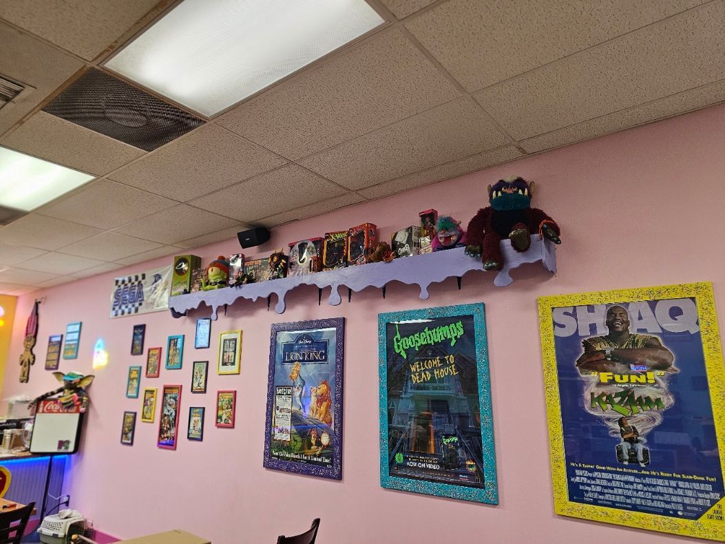 A room with a lot of posters on the wall including one that says shack