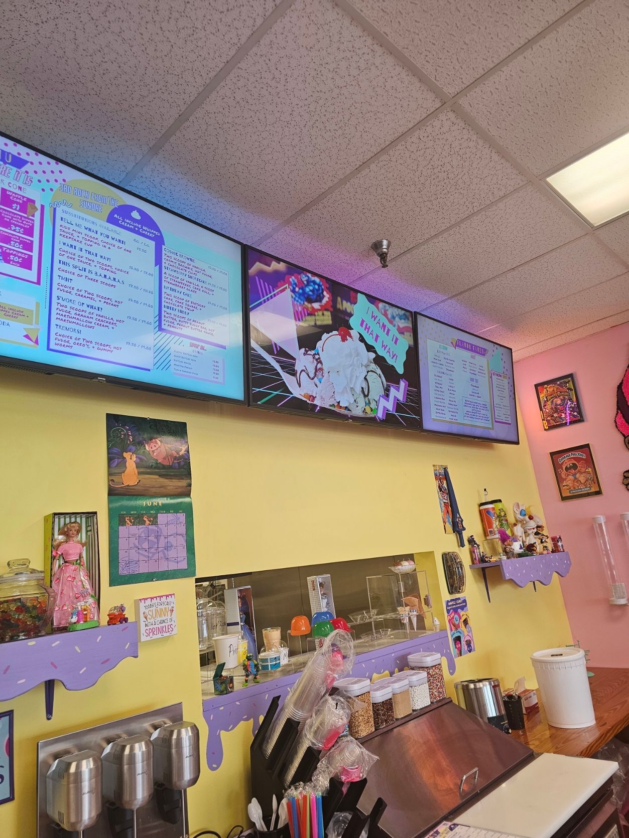 A restaurant with a lot of screens on the wall