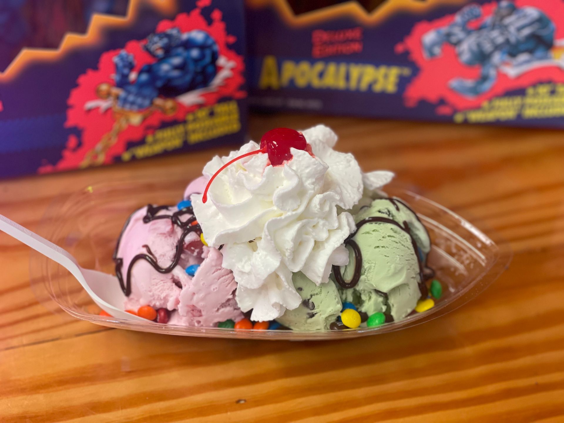A bowl of ice cream with whipped cream and a cherry on top