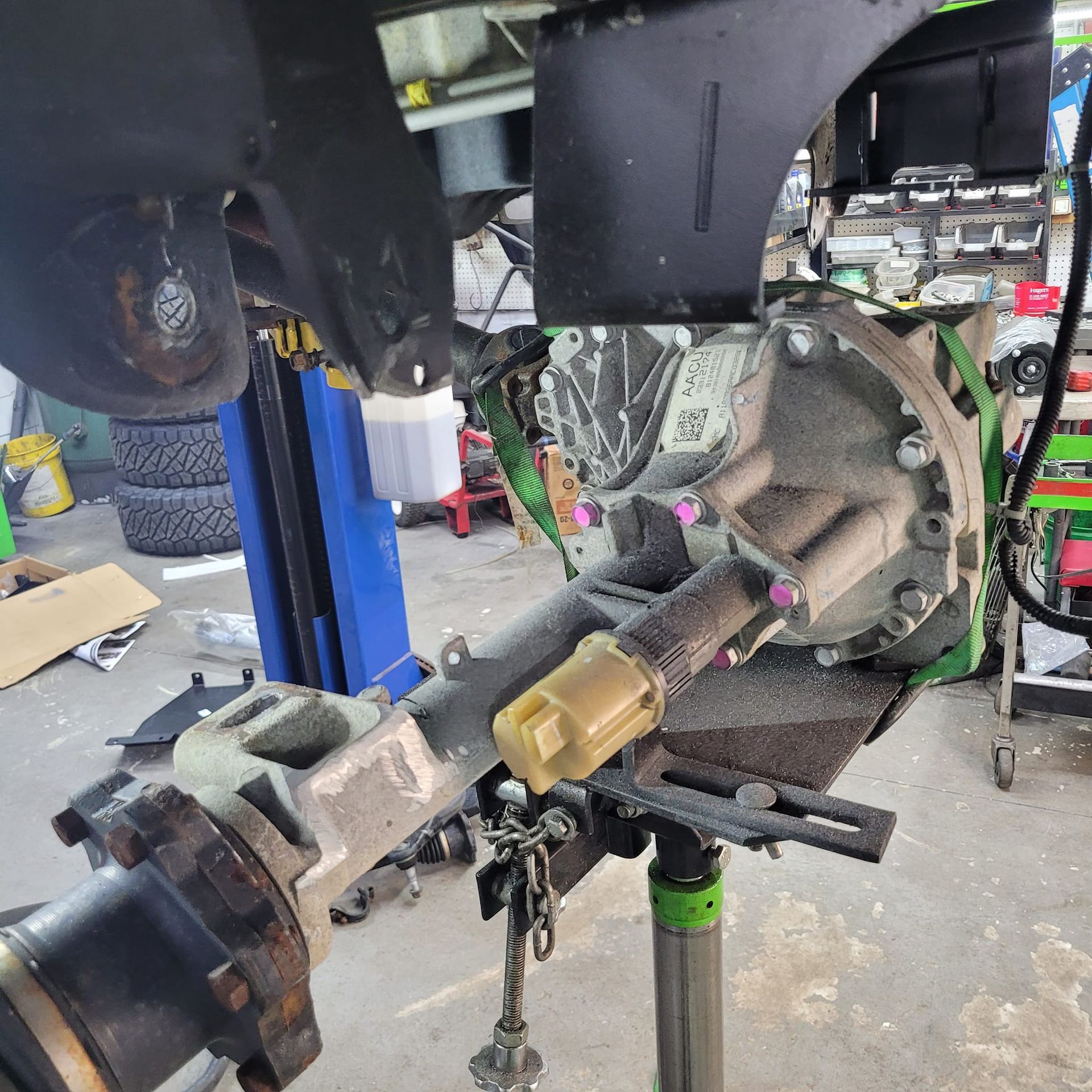 The Rear End of A Vehicle Is Being Worked on In a Garage