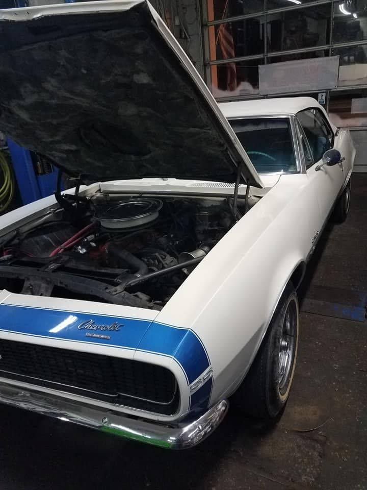 A White and Blue Car with The Hood Open