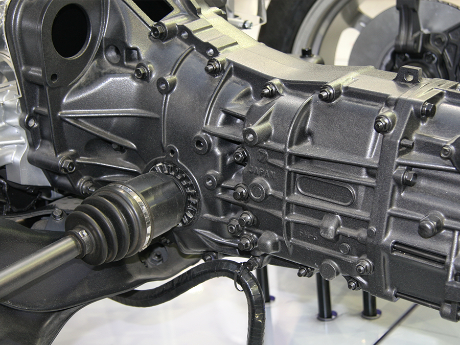 A close up of a car engine with a drive shaft