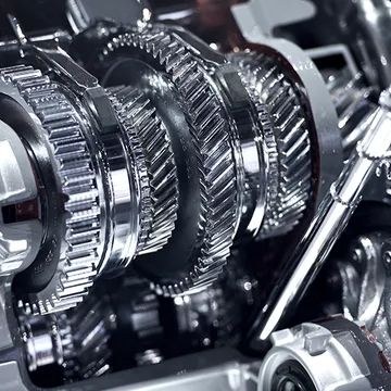 Close-up of shiny gears, likely part of a car transmission.