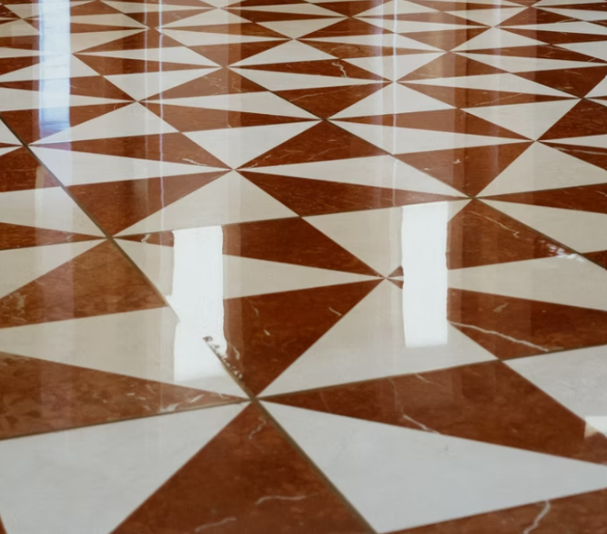 Pavimento piastrellato con motivi geometrici marroni e bianchi e riflessi lucidi