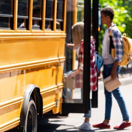 students boarding a school bus