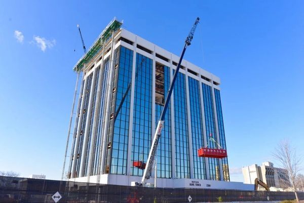 A large building with a lot of windows is being built.