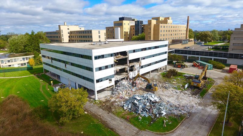 An aerial view of a large building being demolished.