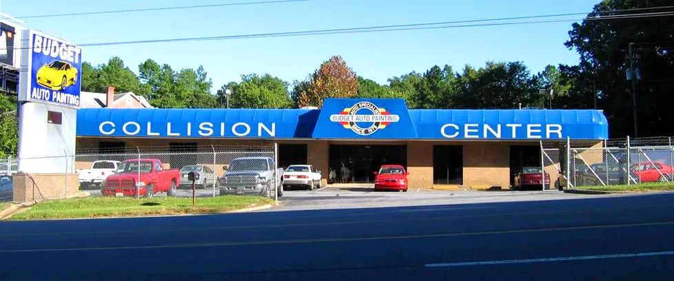 A collision center with cars parked in front of it