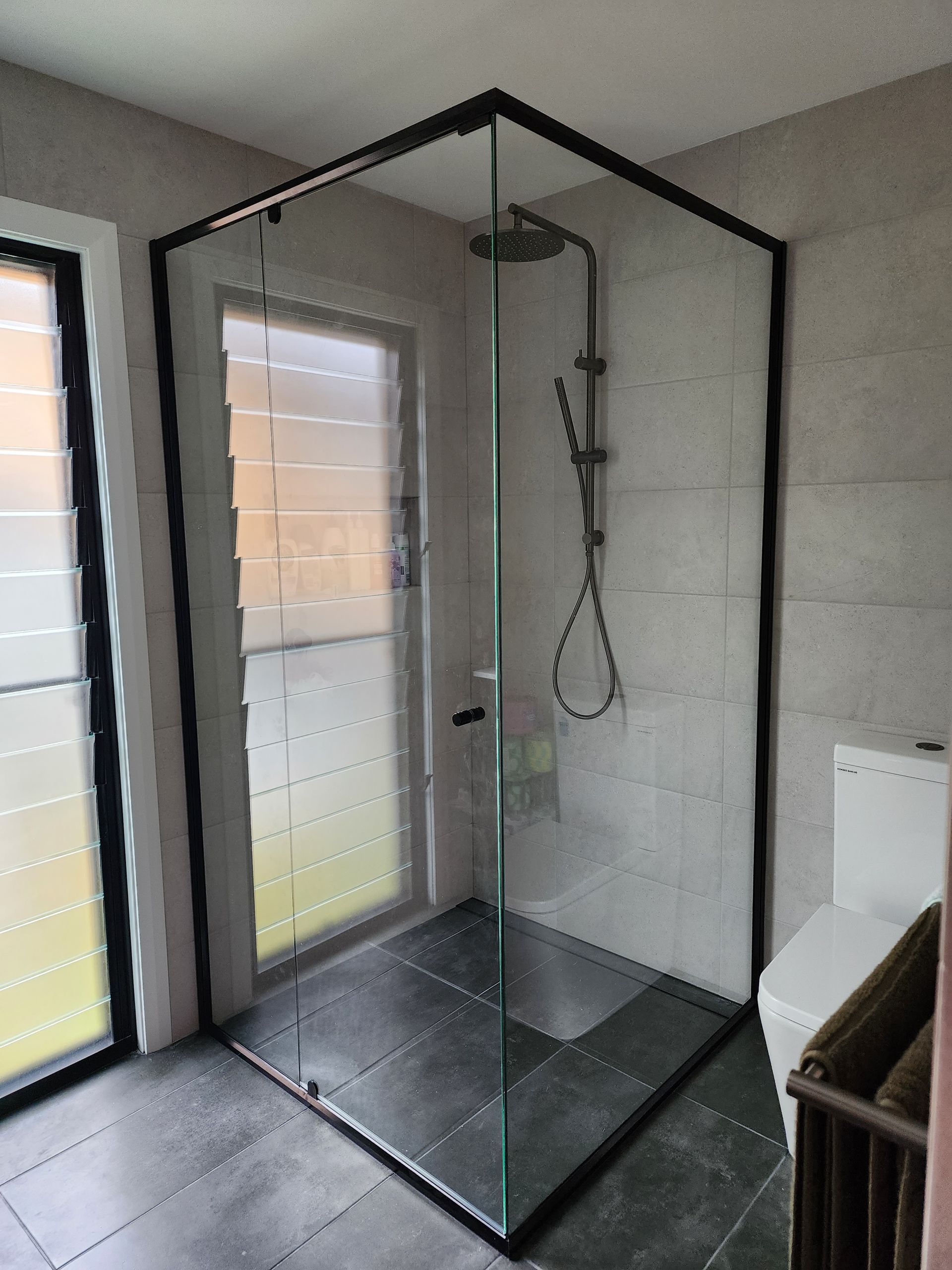 A Bathroom With A Shower Stall With A Gold Frame — Lumba Glass & Glazing In Kincumber, NSW 