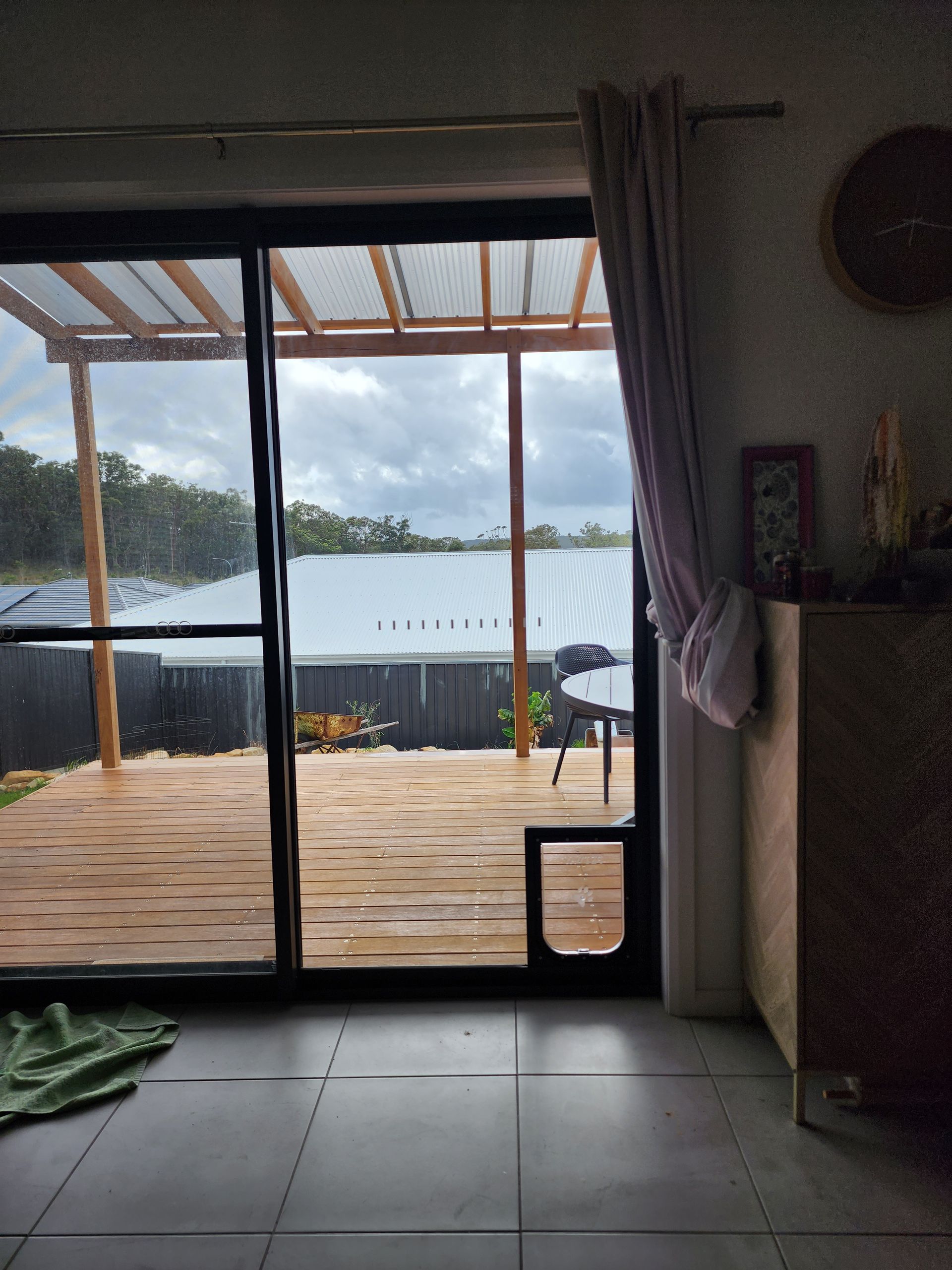 A Person In A Wheelchair Is Looking Out Of A Window At A Lake — Lumba Glass & Glazing In Kincumber, NSW