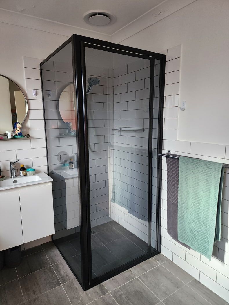 A Bathroom With A Walk In Shower And A Sink — Lumba Glass & Glazing In Kincumber, NSW