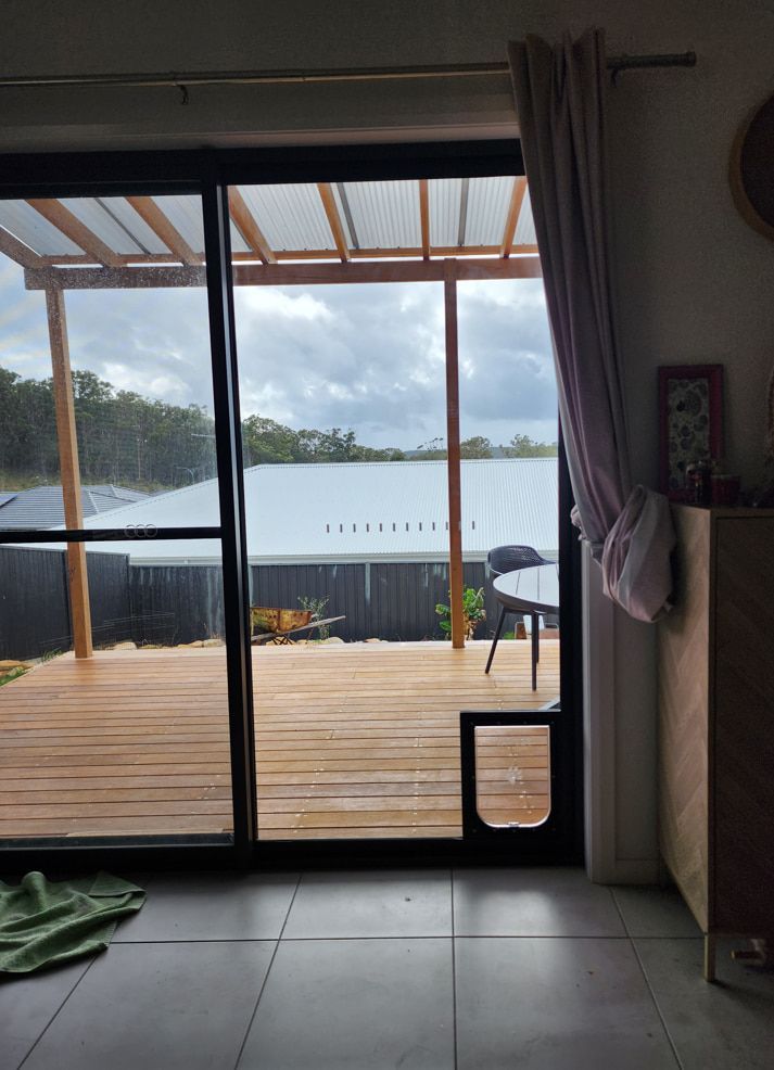 A Room With A Sliding Glass Door Leading To A Deck — Lumba Glass & Glazing In Kincumber, NSW