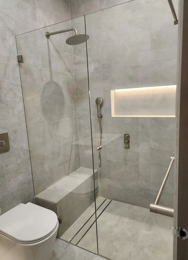A Bathroom With A Toilet And A Walk In Shower — Lumba Glass & Glazing In Kincumber, NSW
