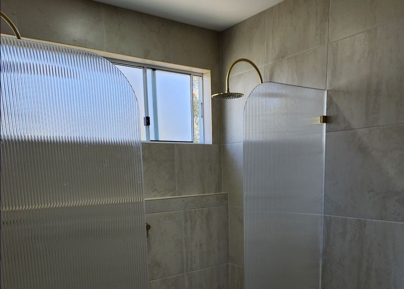 A Bathroom With A Shower Stall And A Window — Lumba Glass & Glazing In Kincumber, NSW