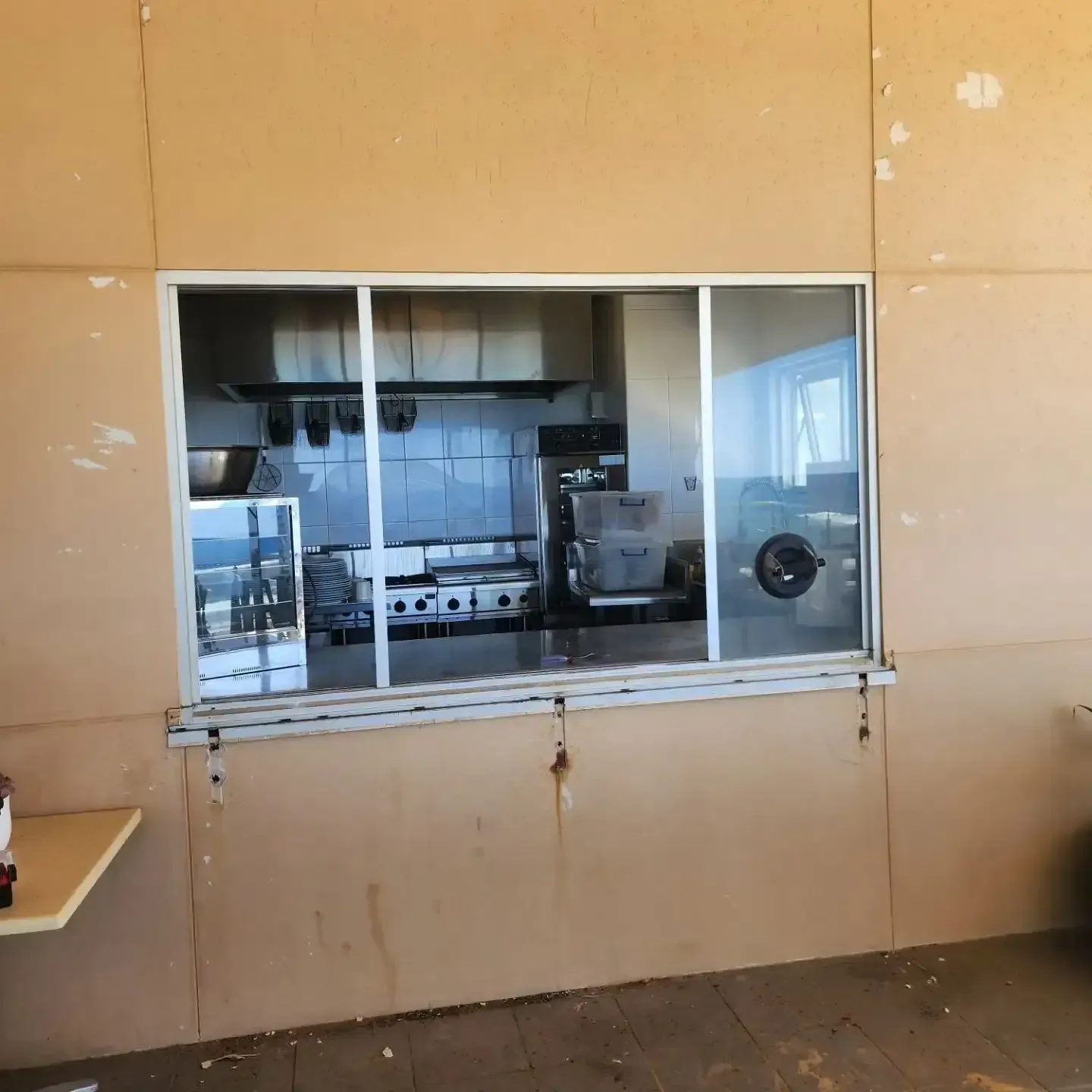 A View Of A Kitchen Through A Large Window — Lumba Glass & Glazing In Kincumber, NSW 