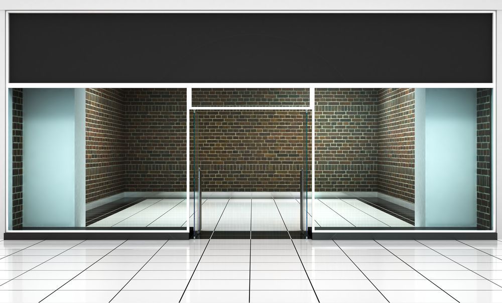 An Empty Store With A Brick Wall And Glass Doors — Lumba Glass & Glazing In Kincumber, NSW 