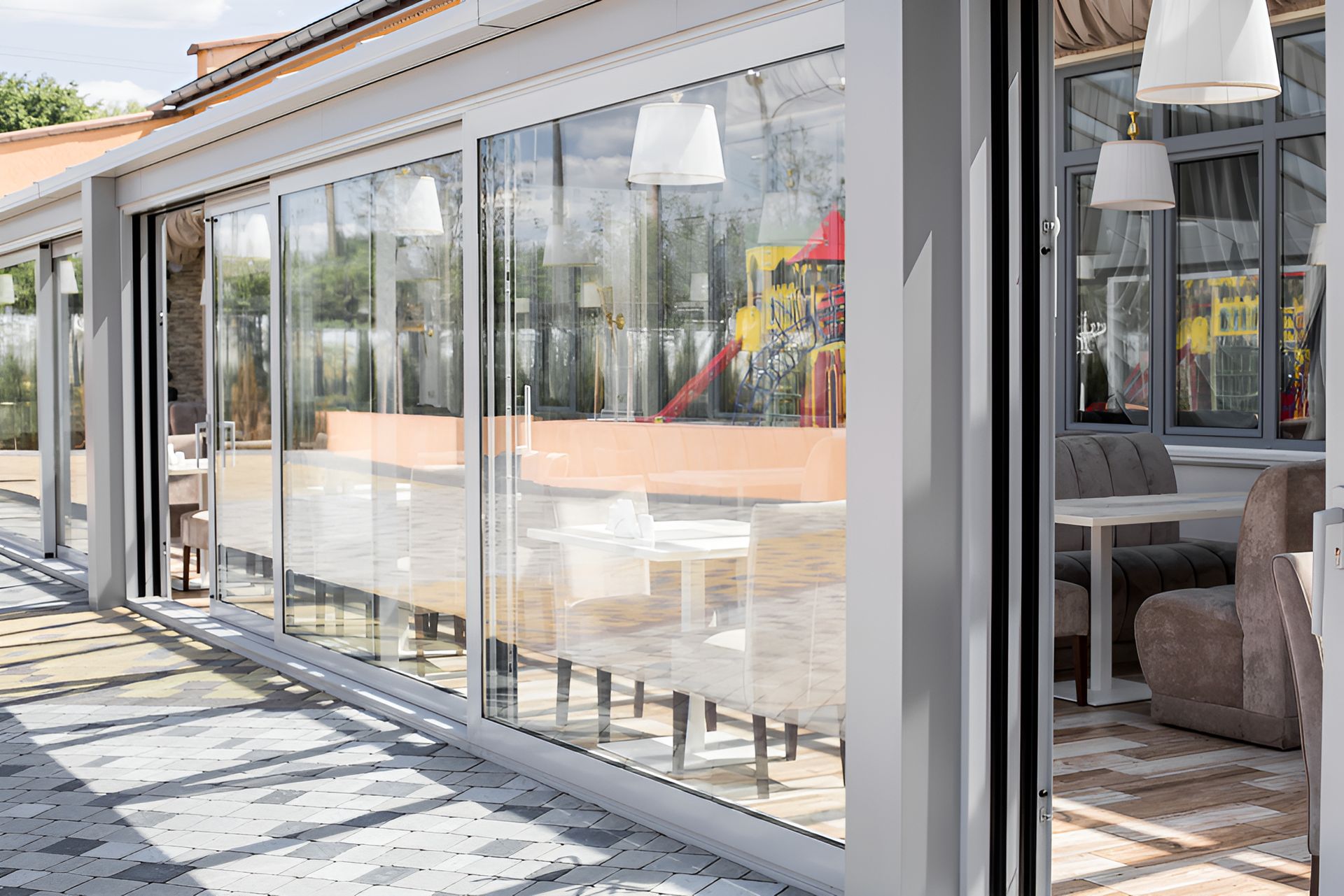 A Large Window With A Reflection Of A Person In It — Lumba Glass & Glazing In Kincumber, NSW