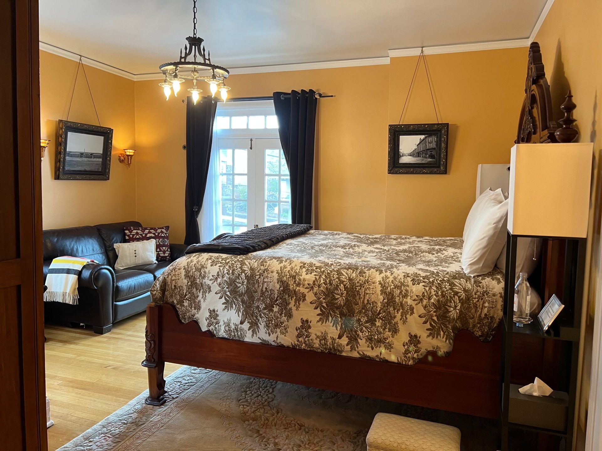 A bedroom with a king size bed and a couch.