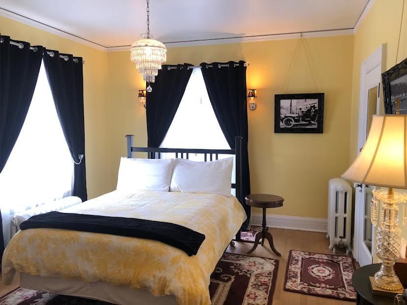 A bedroom with a bed and two lamps