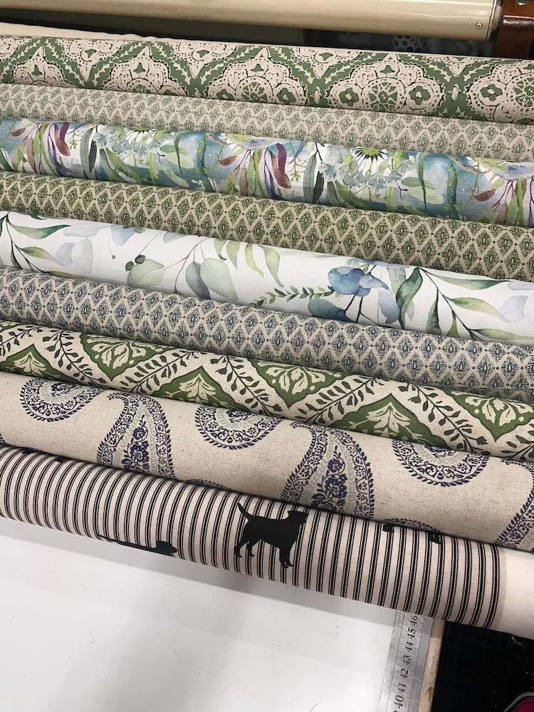 A Bunch of Rolls of Fabric Are Stacked on Top of Each Other on a Table — Tamworth Interiors in Quirindi, NSW