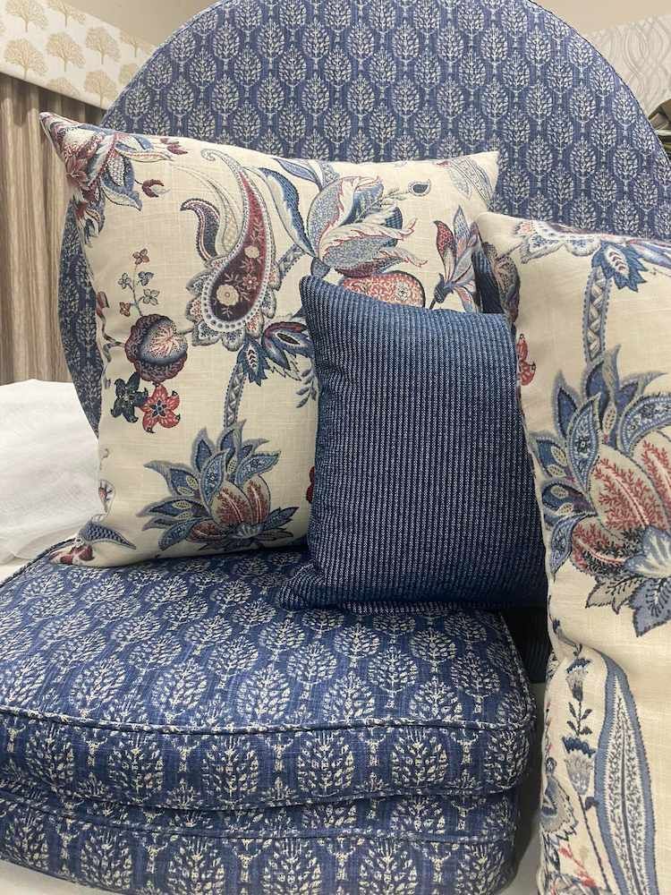 A Stack of Blue and White Pillows Sitting on Top of Each Other on a Bed — Tamworth Interiors in Armidale, NSW 