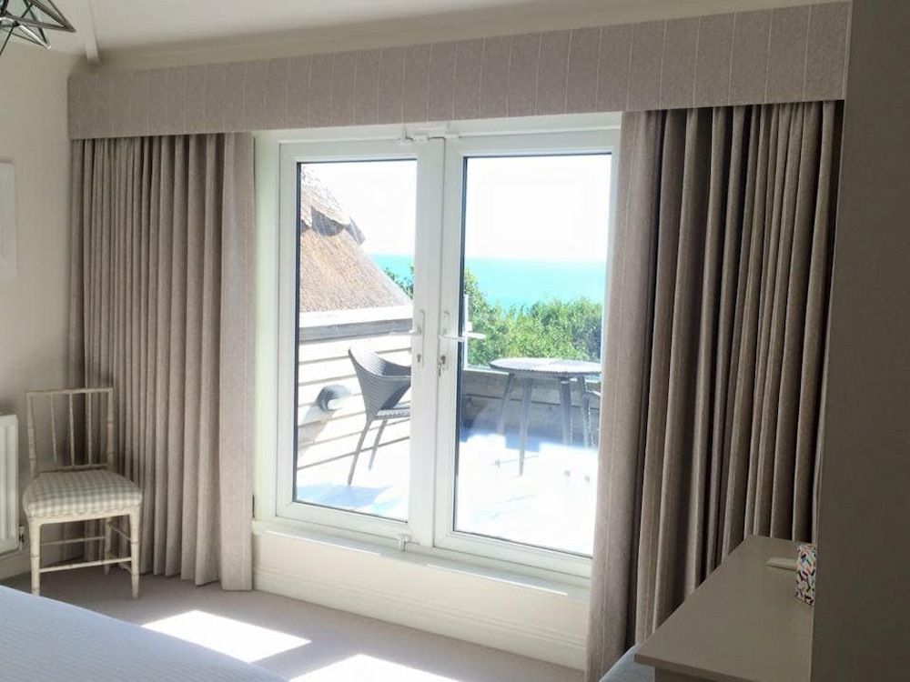 A Bedroom With a Large Window and Curtains — Tamworth Interiors in Quirindi, NSW