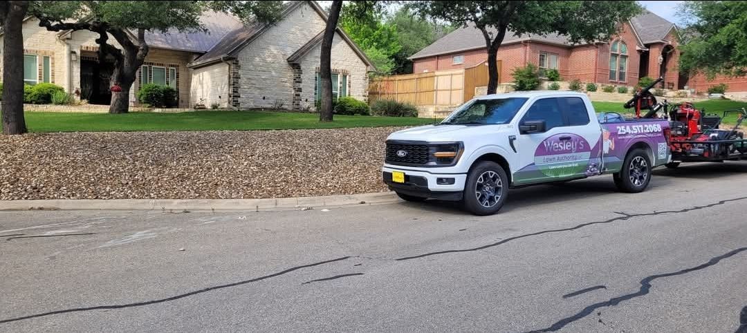 A white truck is parked on the side of the road next to a house.
