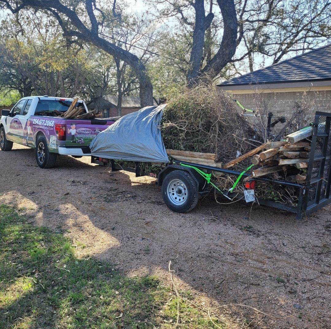 A truck is pulling a trailer with a motorcycle on it.